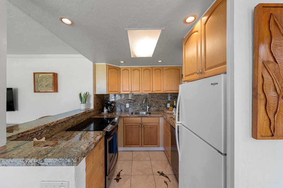 Fully equipped kitchen with granite counters and modern appliances.