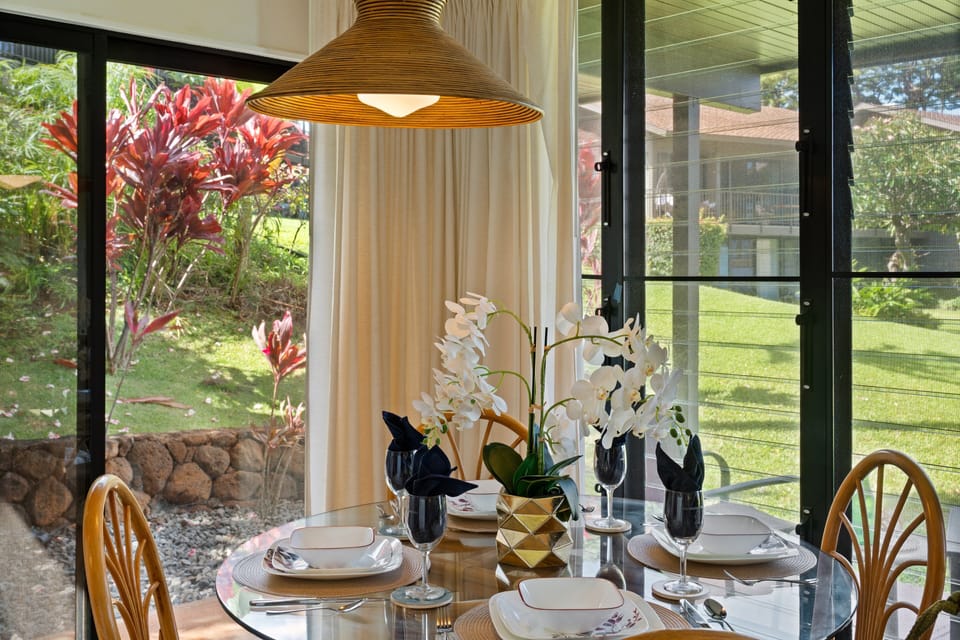 Dining area with garden views and natural light from large windows.