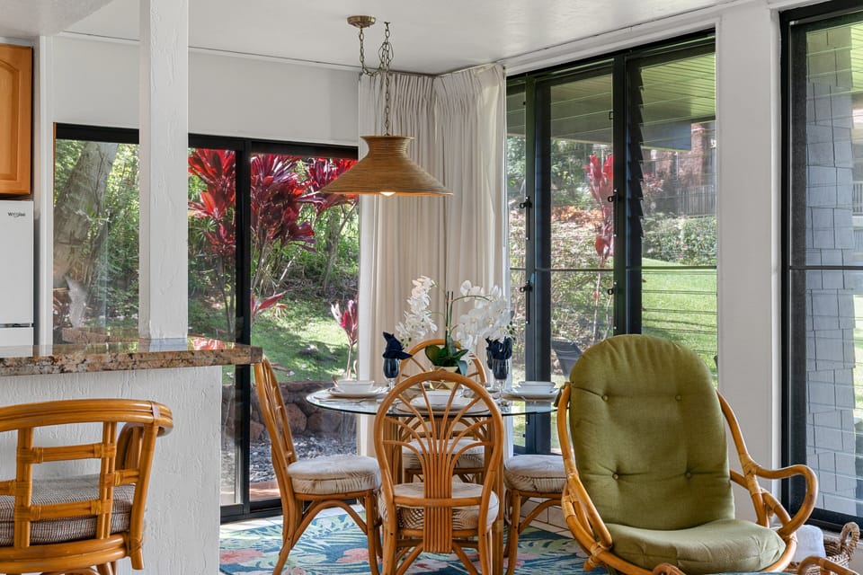 Breakfast nook with seating, garden views, and bright open layout.