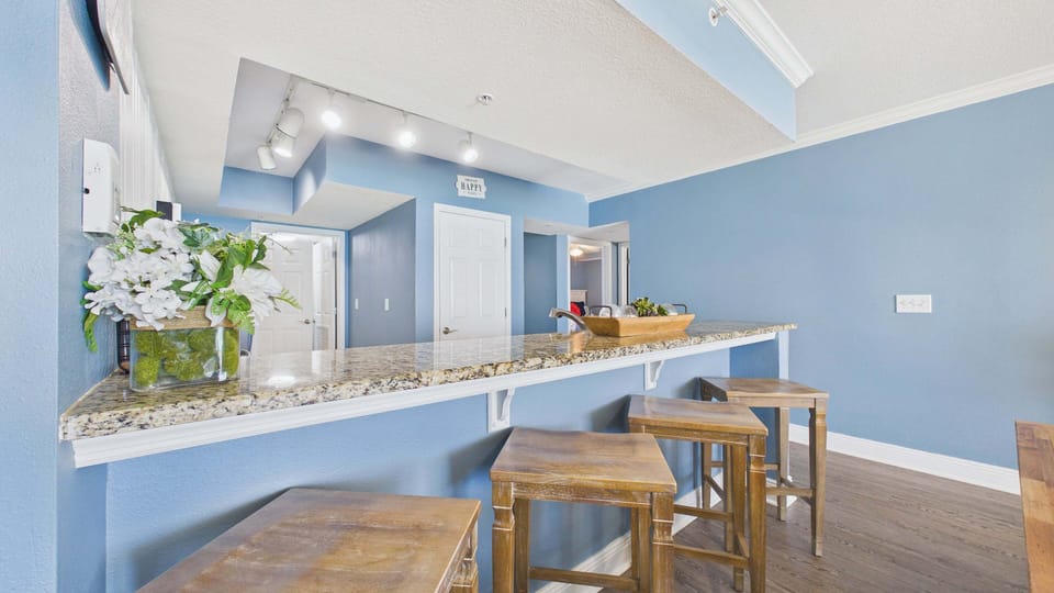 Breakfast bar attached to kitchen counter with bar stool seating
