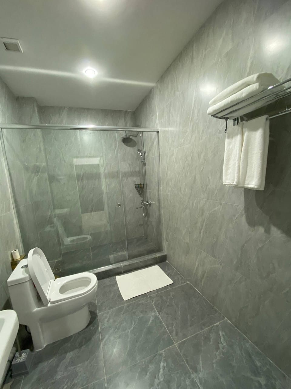 Shower, hair dryer, slippers, towels