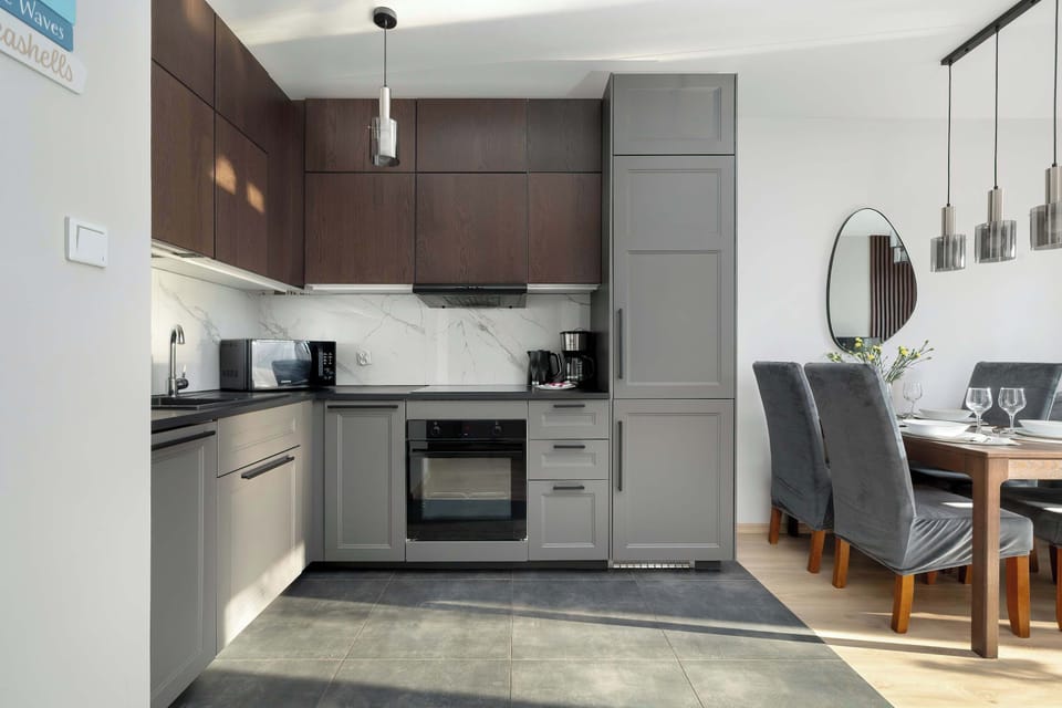 The kitchen is fully equipped with high-end appliances, including a built-in oven, microwave, and dishwasher integrated into the cabinetry. It provides everything needed for guests who enjoy cooking their own meals.