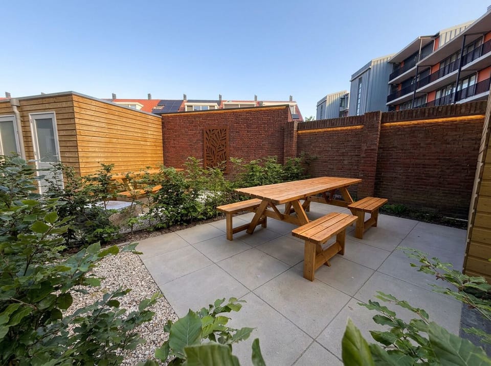Private garden with outdoor seating and dining area, offering a quiet space to relax, enjoy meals, and unwind in the fresh air.