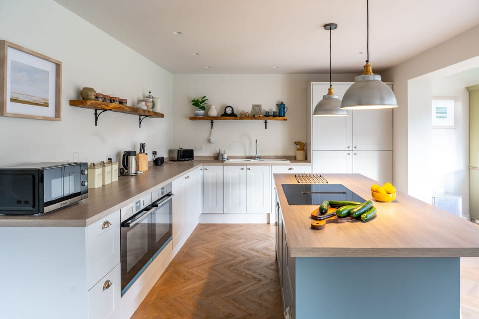 Ground floor: Kitchen with double oven, microwave, dishwasher, fridge/freezer and larder cupboard