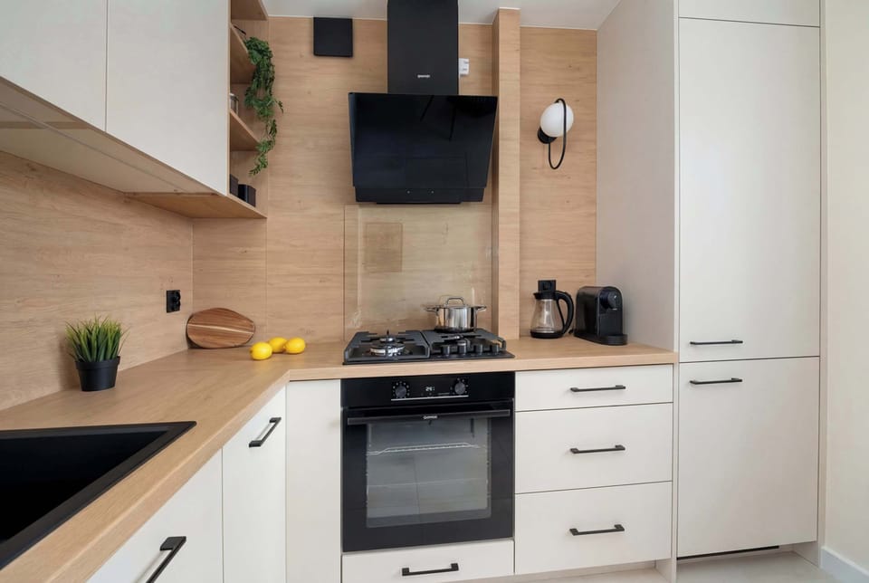 A close-up of the kitchen counter with appliances and storage. The design emphasizes functionality. Light colors make the area feel larger.