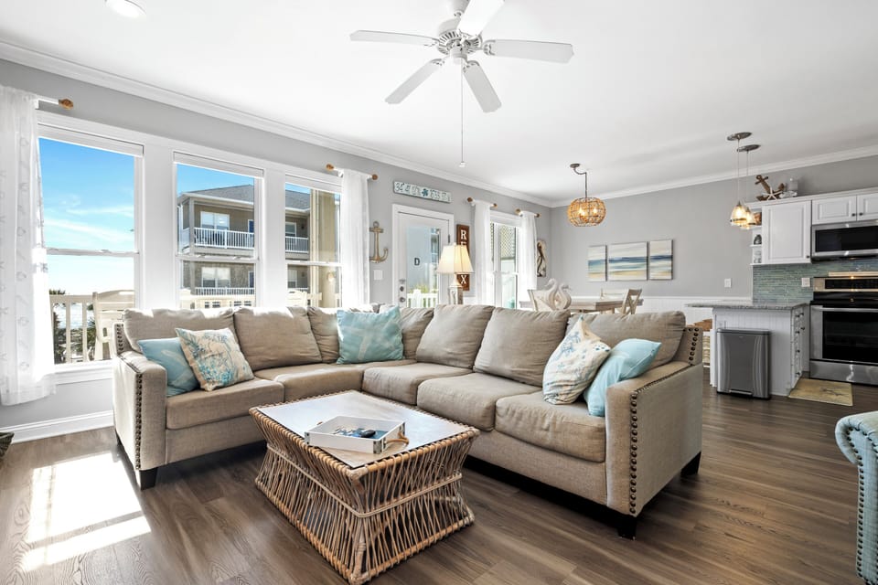 Sink into this plush sectional where coastal breezes meet modern comfort. Your open-plan sanctuary blends beachy vibes with sleek style.