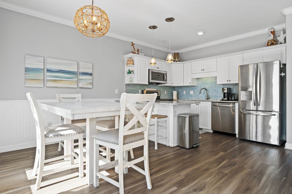 Your bright, coastal-inspired kitchen awaits with modern appliances and a cozy dining nook for memorable meals together.