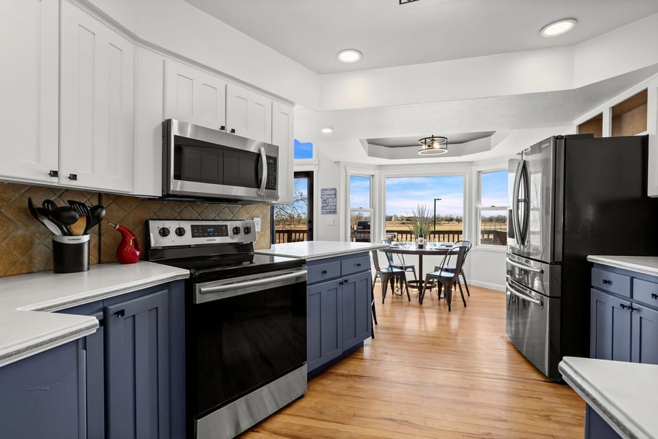 Your fully equipped kitchen features modern appliances and flows into a bright dining nook with stunning views.