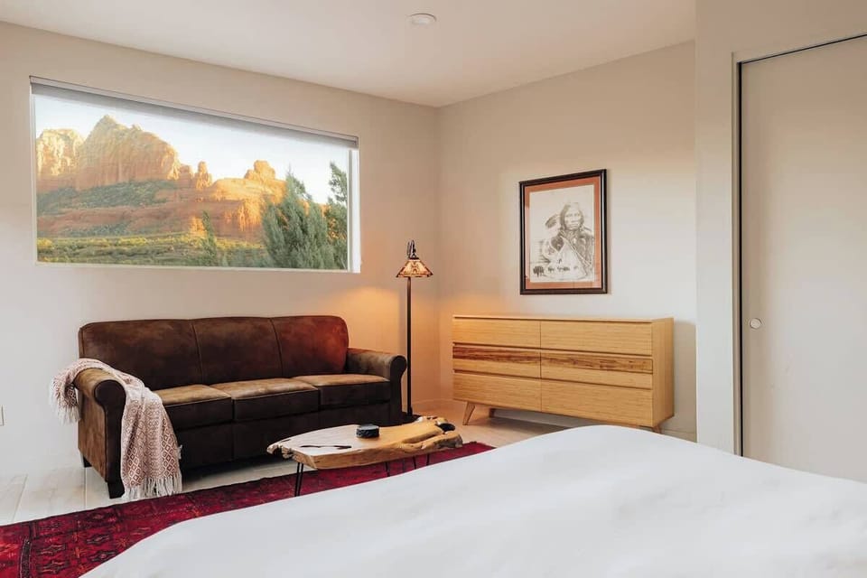 Your private retreat features a cozy leather sofa and stunning mountain views, perfect for morning coffee or evening relaxation.