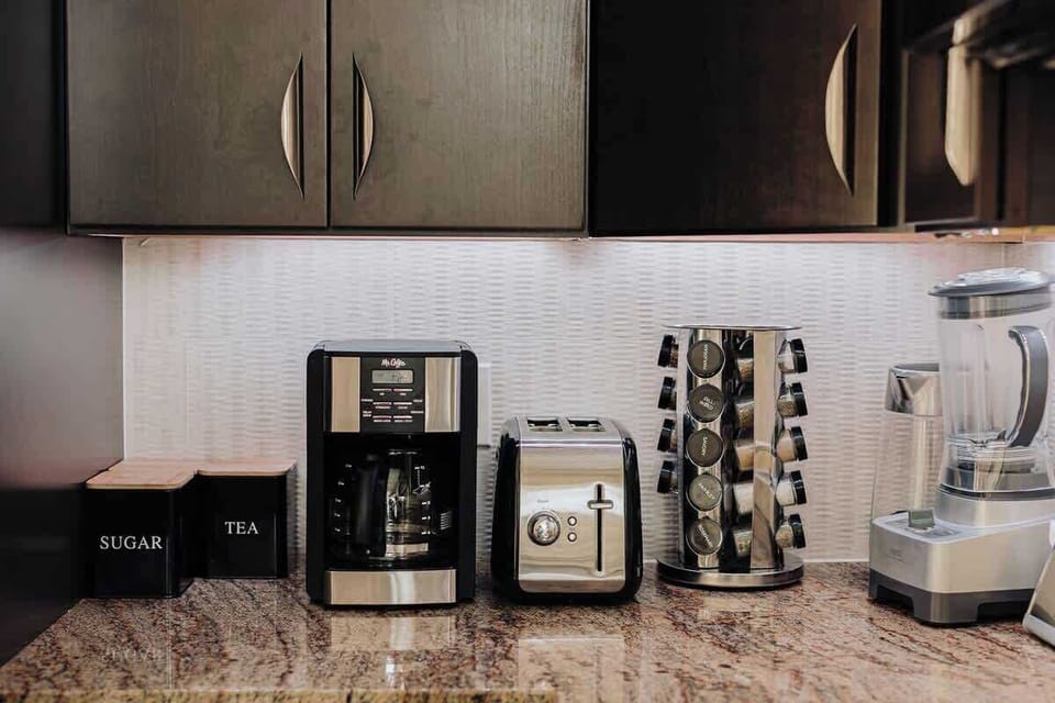 Your morning ritual awaits with premium coffee maker, toaster, and blender ready for delicious homemade beverages and meals.
