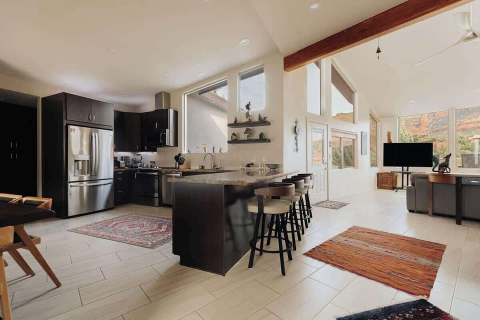 Your spacious kitchen flows seamlessly into the living area, featuring modern appliances and a breakfast bar where you'll love gathering.