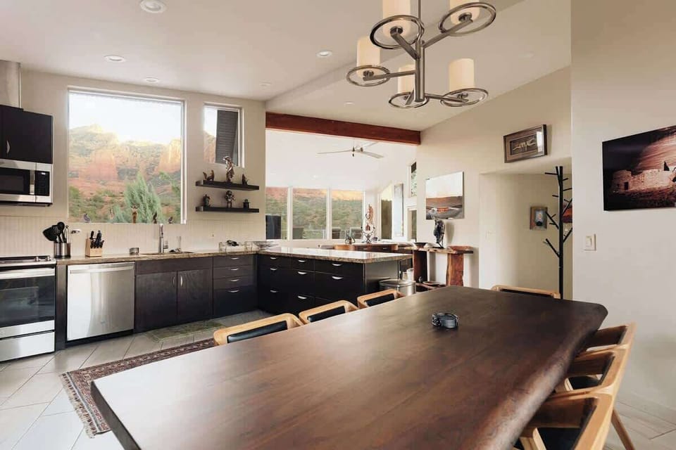 Your gourmet kitchen and dining space flows seamlessly together, featuring granite counters and a stunning live-edge table perfect for memorable meals.