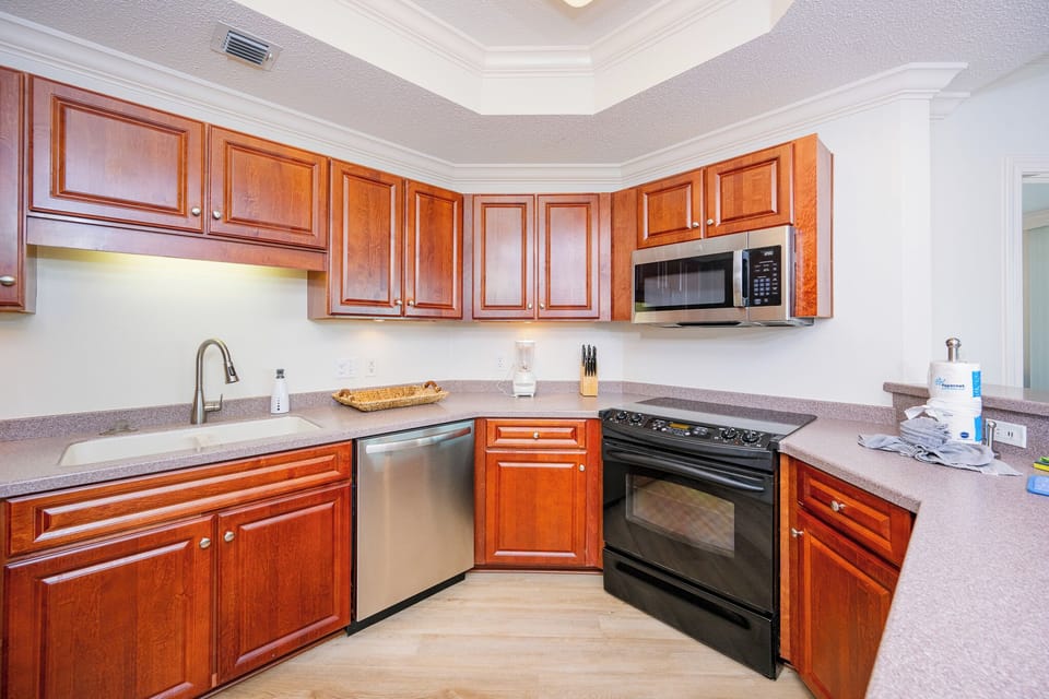 Craft delicious meals surrounded by warm wood cabinetry and ample counter space, enhancing your culinary experience