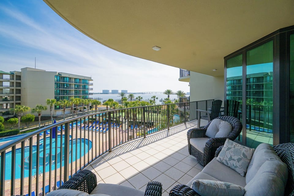 Relax on the balcony, taking in the refreshing coastal breeze and stunning views of the shimmering pool below