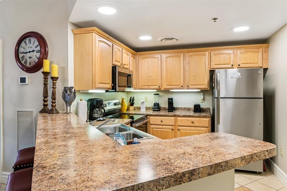 Your fully equipped kitchen features granite countertops, stainless steel appliances, and ample cabinet space for preparing memorable meals together.