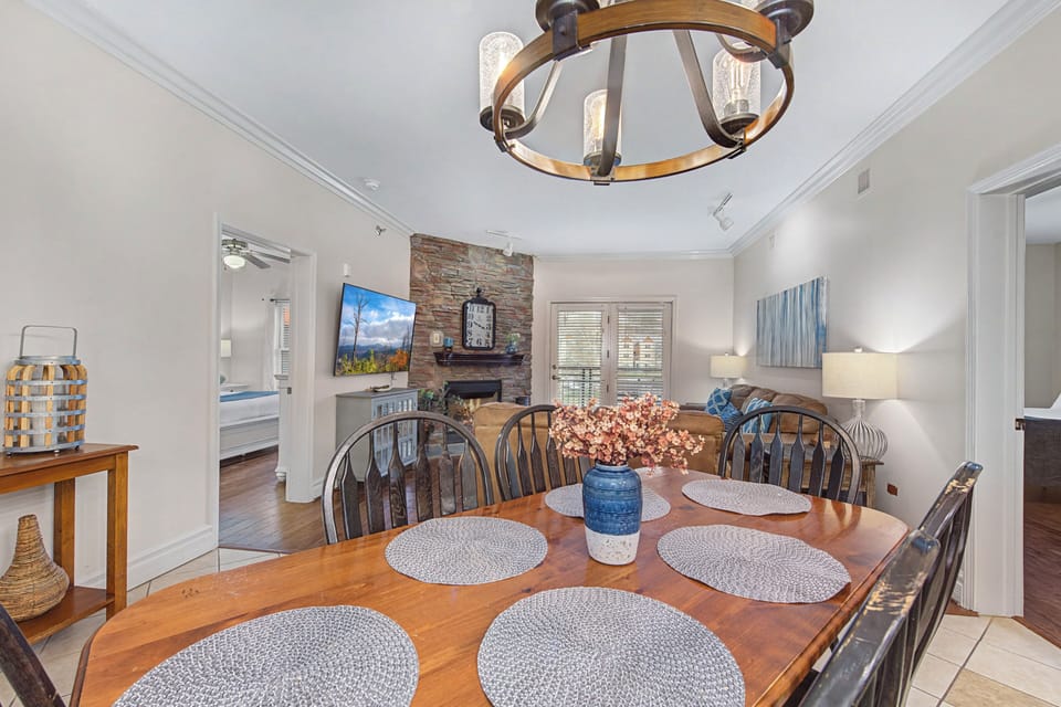 Gather around your elegant dining table for memorable meals, with the stone fireplace creating the perfect cozy backdrop.