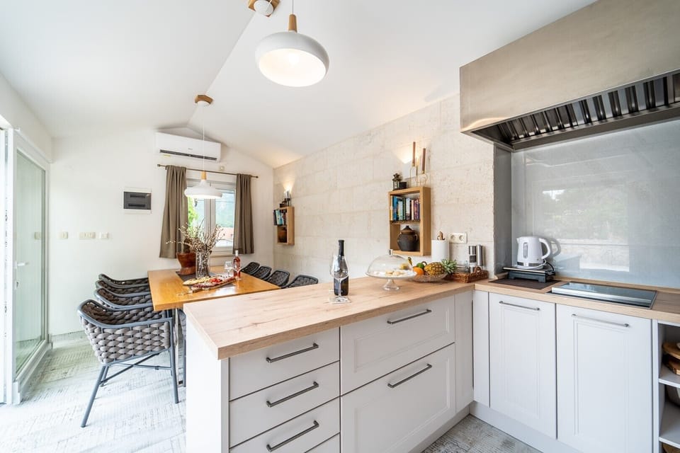  Summer kitchen with a dining table for 10 people with sliding glass doors toward the pool