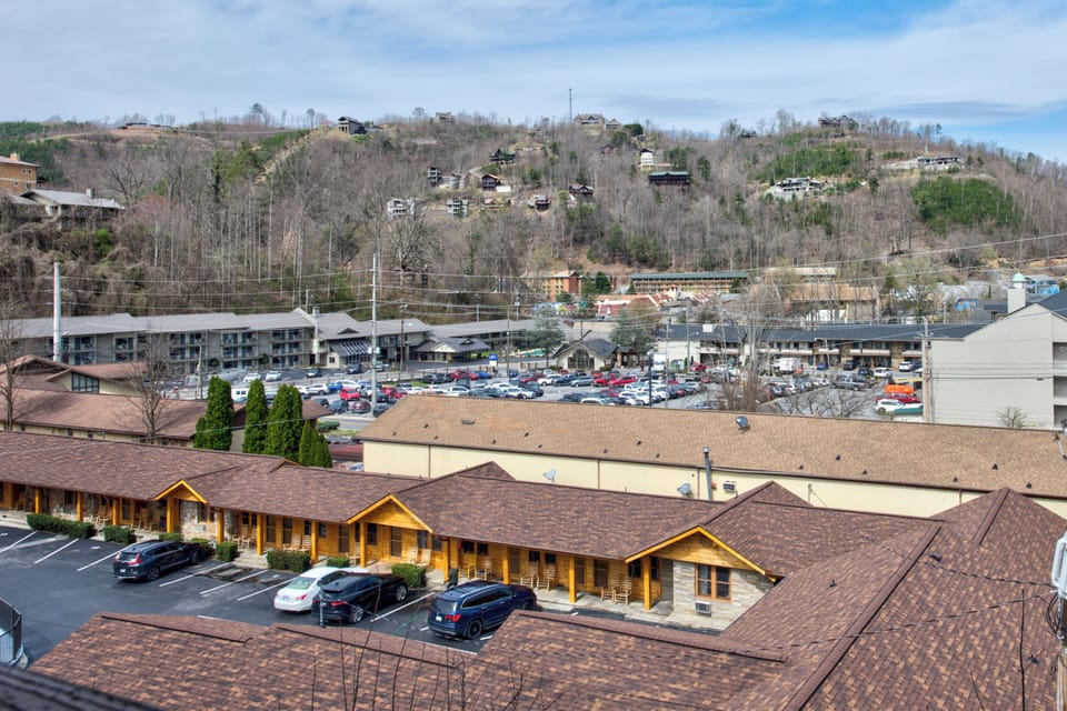 Aerial view of the property nestled in a scenic mountain valley with convenient parking and nearby town amenities.