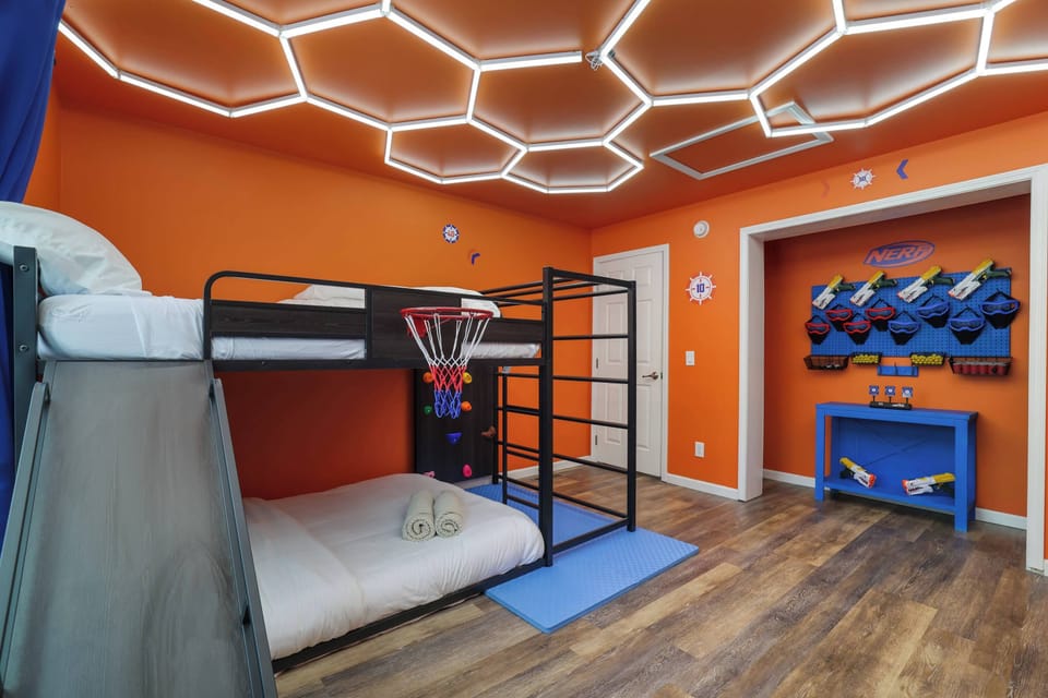Bright orange walls, a bunk bed with a slide, plus a basketball hoop for hours of play!
