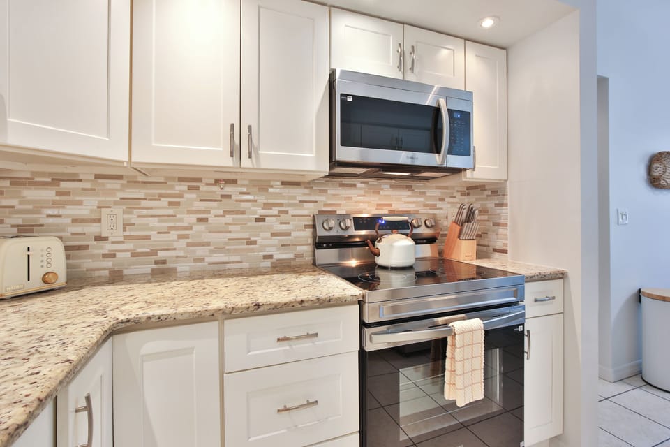 Your fully equipped kitchen features granite countertops, modern appliances, and everything you need to create memorable meals during your stay.