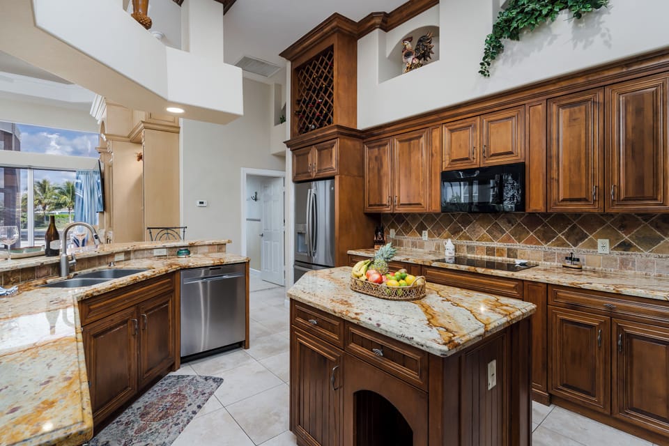 Your gourmet kitchen features rich wood cabinetry, stunning granite countertops, and premium appliances perfect for preparing memorable meals during your stay.
