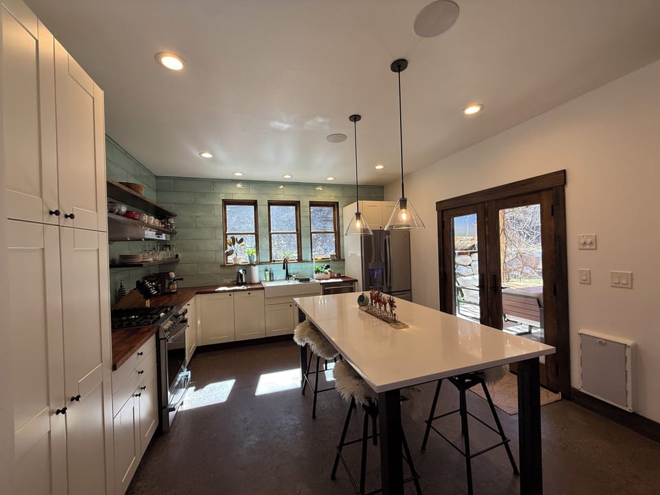Kitchen with espresso maker, microwave in cupboard, large double farmhouse sink