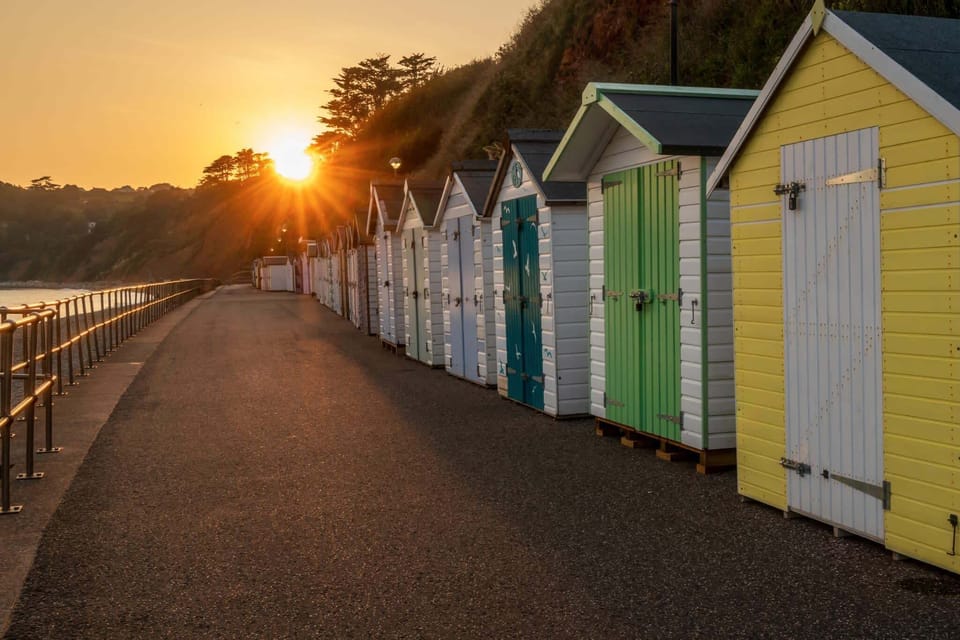 A row of vibrant beach huts adding character to Seaton’s coastline
