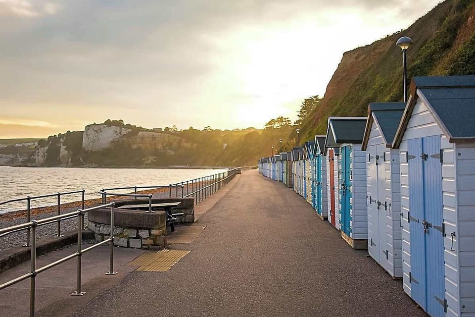 Colorful beach huts lining the seafront, full of classic seaside charm