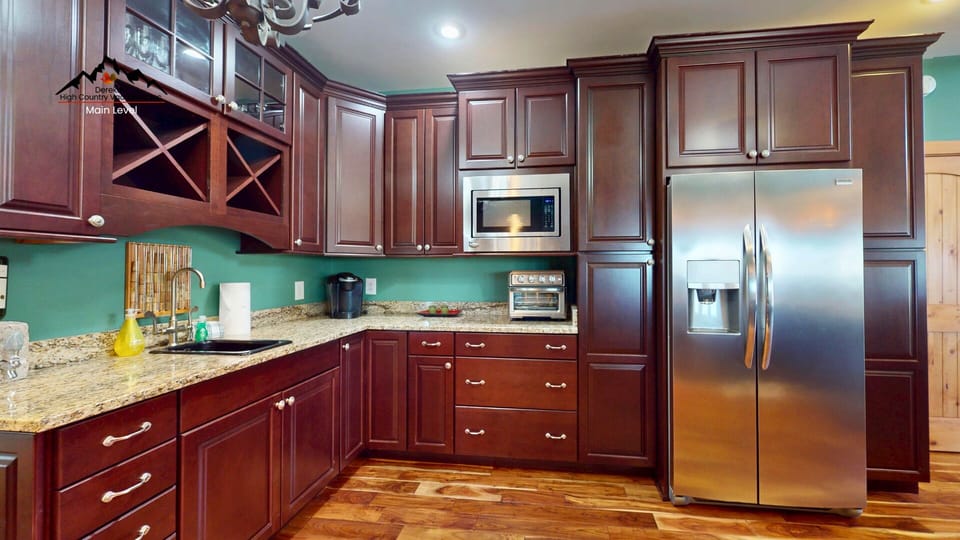 Your fully equipped gourmet kitchen awaits with granite counters, stainless appliances, and rich cherry cabinets—perfect for creating memorable meals.