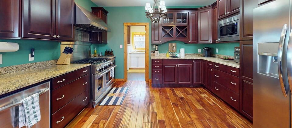 Create culinary masterpieces in this spacious gourmet kitchen featuring rich cherry cabinets, granite counters, and premium stainless steel appliances.