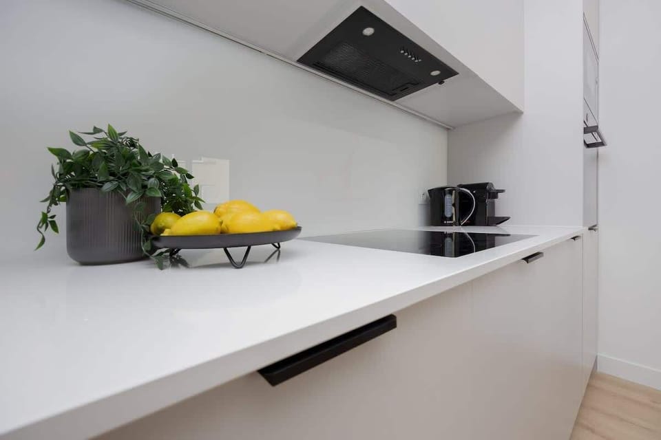 The sleek design of the kitchenette blending seamlessly with the living area.