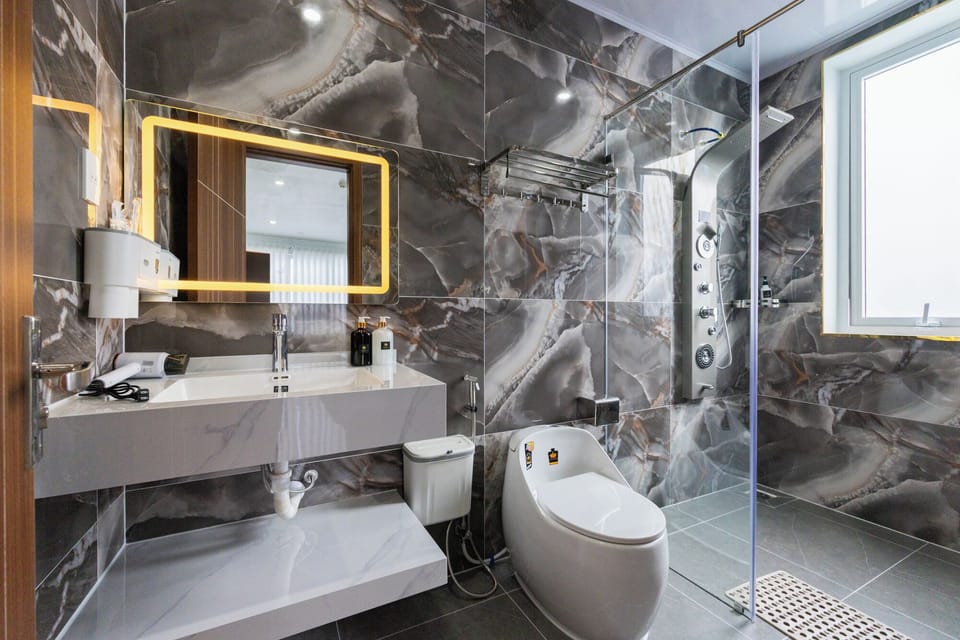 Family Quadruple Room, Courtyard View | Bathroom | Shower, hair dryer, slippers, towels