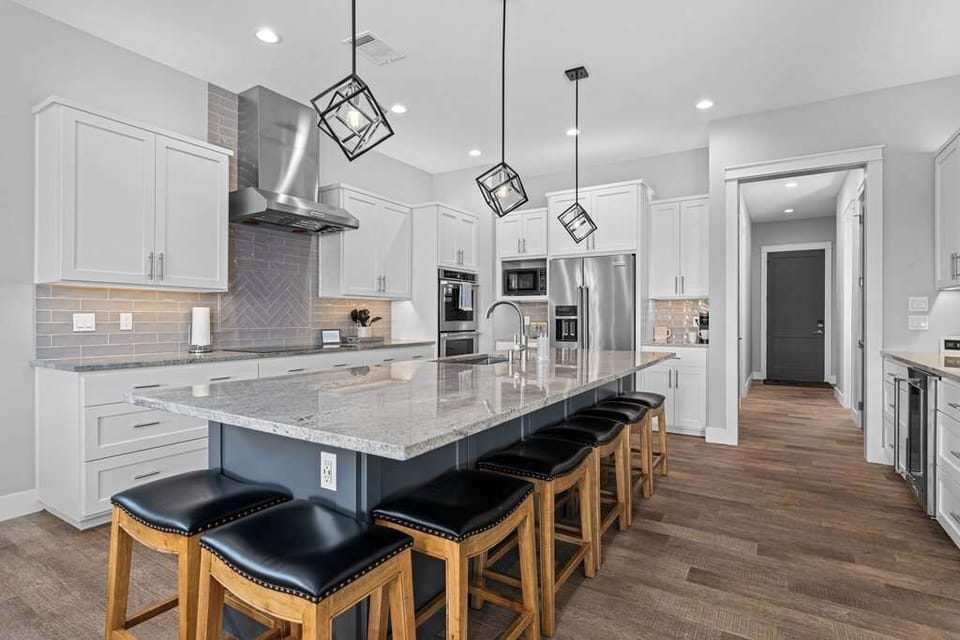 Modern kitchen with large island and bar seating.