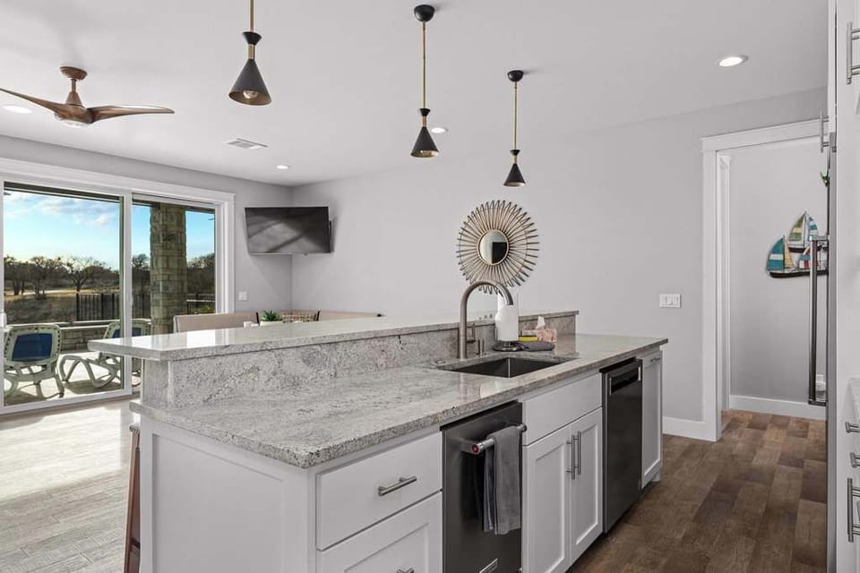 Modern kitchen with island and bar seating.