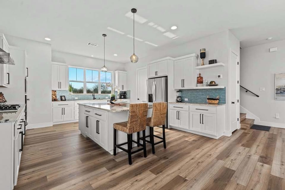 Bright, modern kitchen with island & bar seating.
