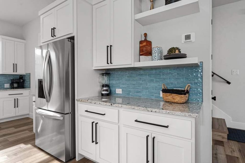 Coffee bar with stainless fridge & stylish storage.