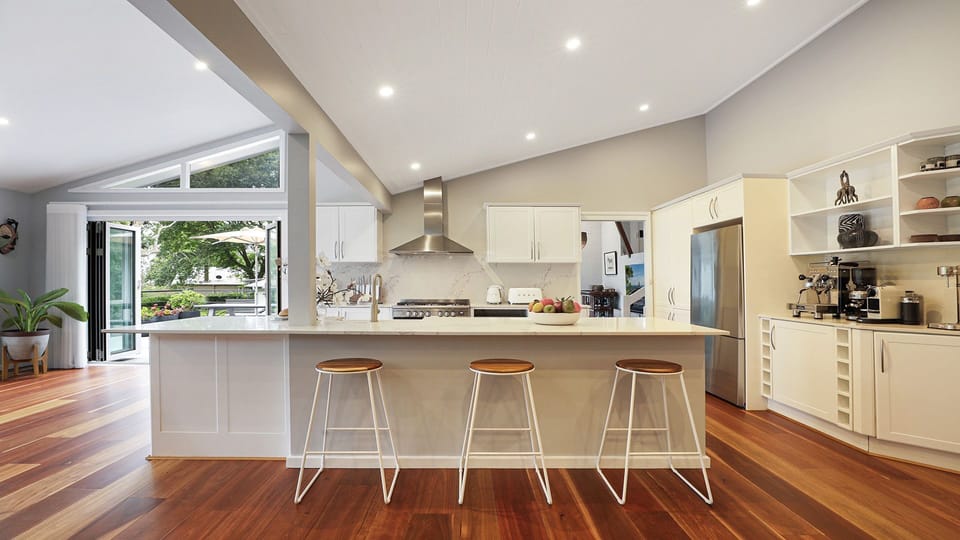 Arcadia Cottage | Kitchen breakfast bar | Back doors open onto beautiful uncovered deck with lounges and alfresco dining | Central ducted heating throughout property