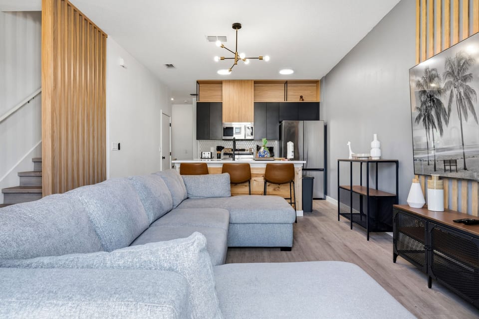 Open-concept living area with sofa, kitchen, and dining space