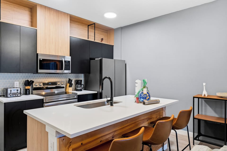 Modern kitchen with island seating and stainless steel appliances