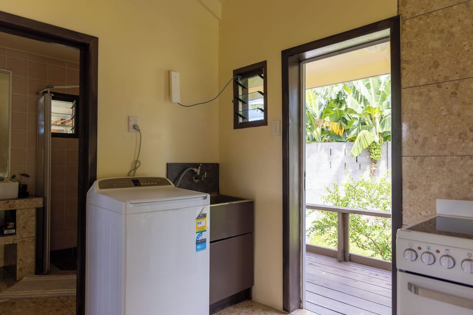 Convenient laundry area with easy access to the bathroom and outdoor deck.