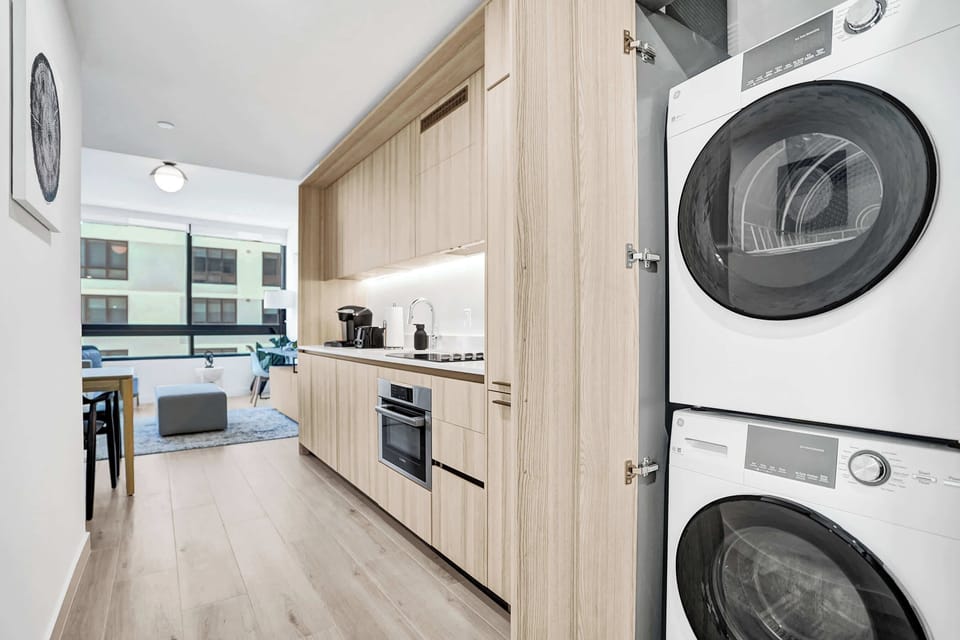 Sleek kitchen with modern appliances and in-unit washer and dryer for added convenience.