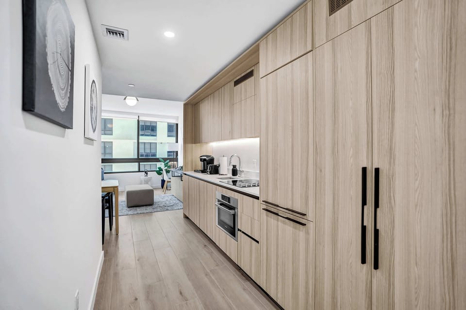 Modern full kitchen with sleek cabinetry and stainless steel appliances—perfect for cooking during your Miami stay.