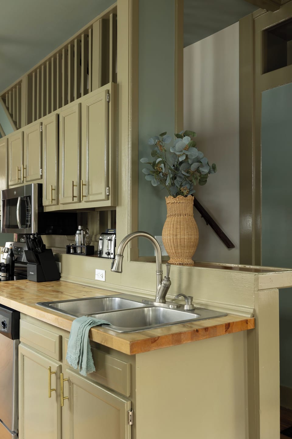 Kitchen: Sage tones, butcher-block counters, and a stocked coffee bar!