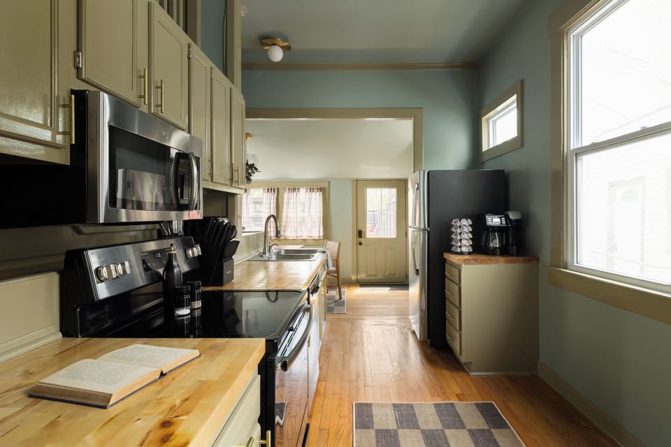 Galley Kitchen: Coffee bar, butcher block, and stainless appliances!