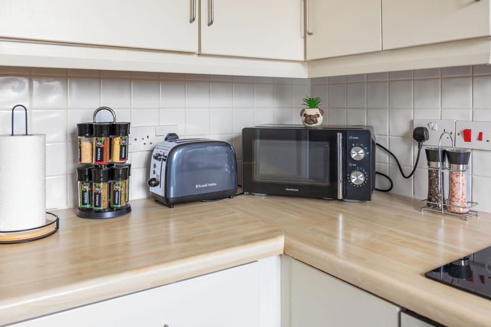 Bright, practical kitchen with microwave, toaster, and handy cooking essentials