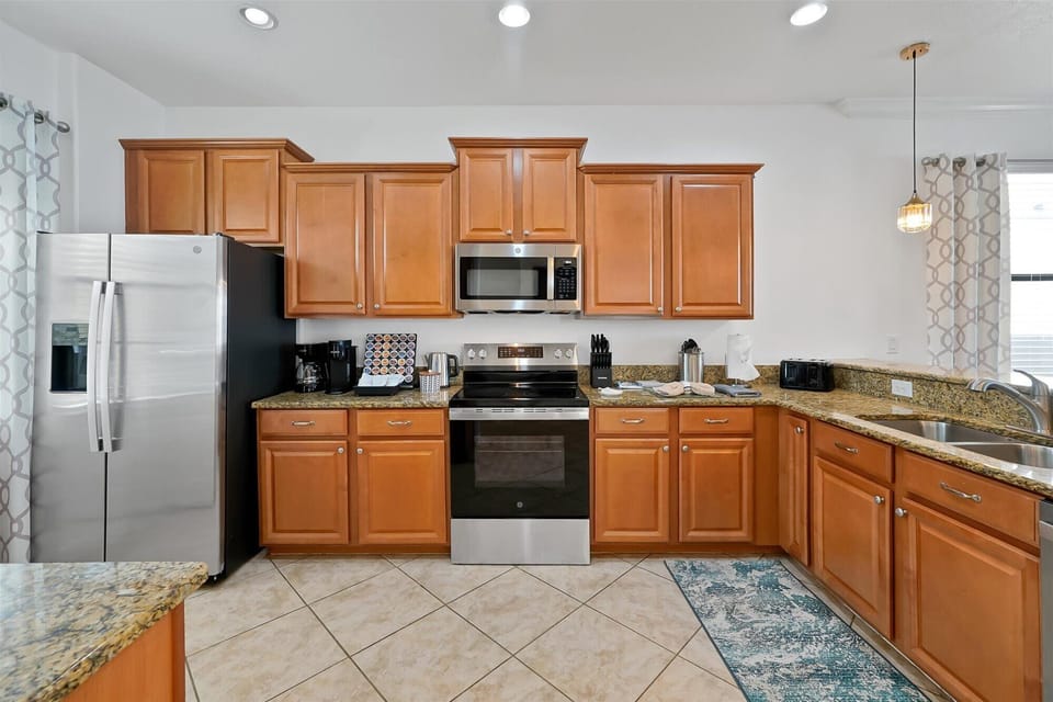 Prepare meals with ease in a fully equipped kitchen featuring ample storage.