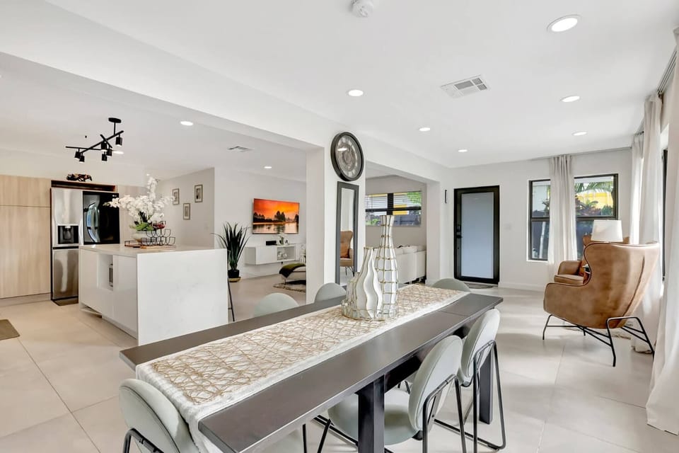 A bright and elegant dining area designed for shared meals and conversations. The open layout connects seamlessly to the kitchen and living space, creating a welcoming atmosphere for gatherings.