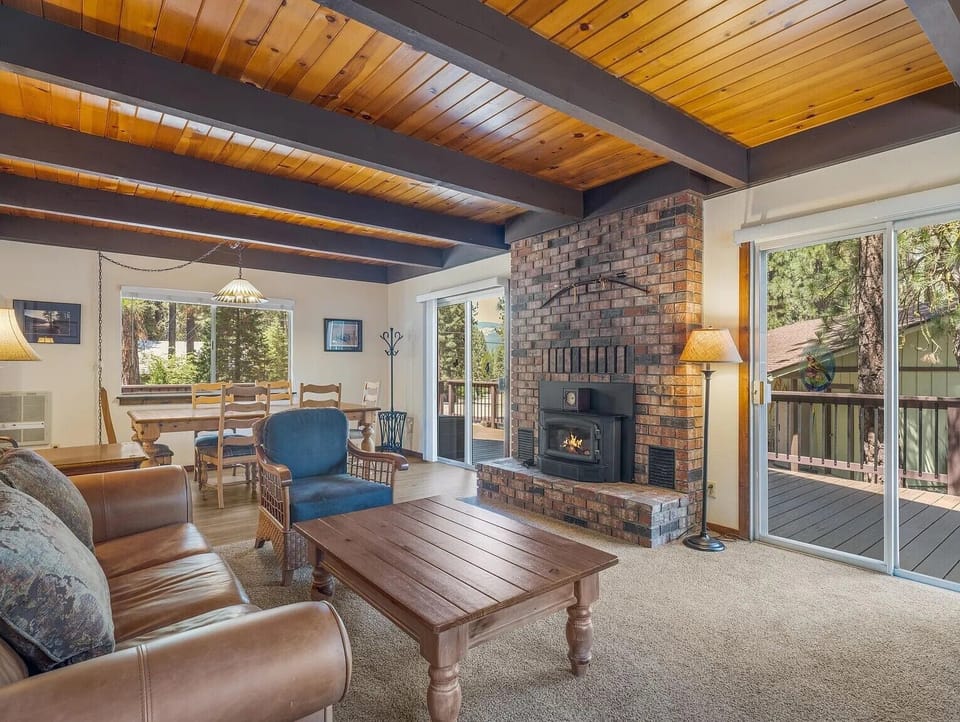 Family room for gathering. Leather sofas, recliner, puzzles, TV, access to deck