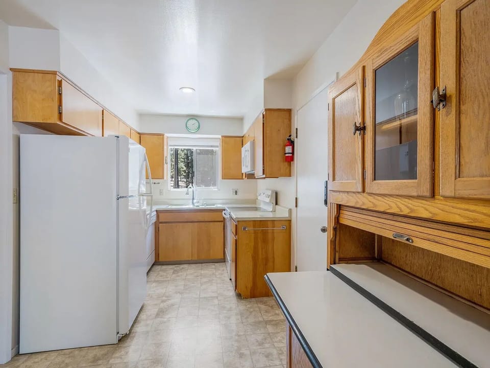 Fully stalked kitchen with dishware and cookware.