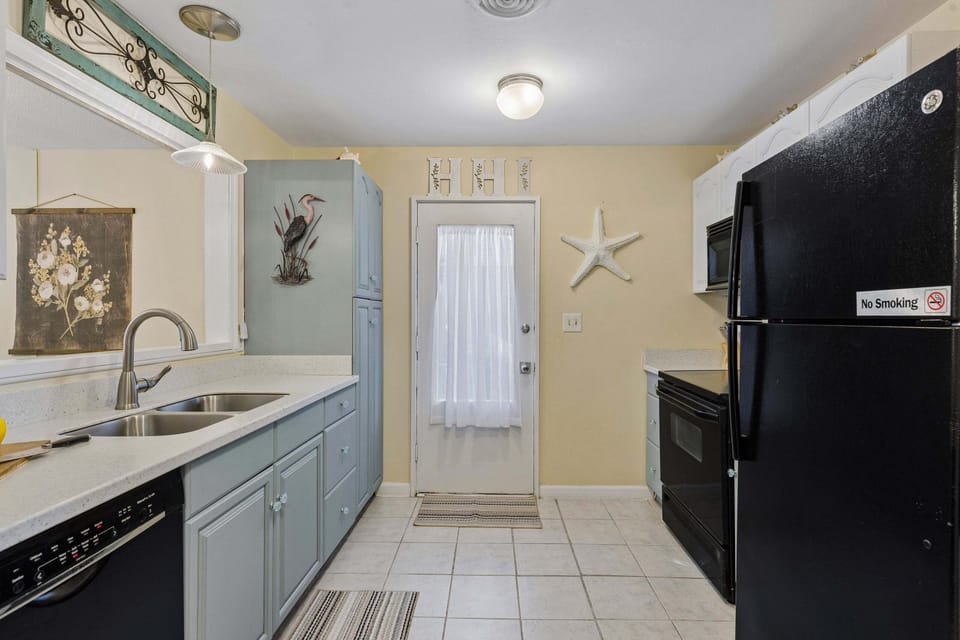 Kitchen with a spacious pantry, microwave, stove, dishwasher, and refrigerator